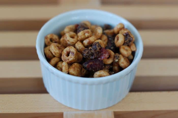 This Cranberry-Chocolate Peanut Butter Trail Mix Recipe is the perfect healthy travel snack or treat for all ages! Full recipe at JessicaLevinson.com #healthytrailmixrecipe #healthytravelsnacks #peanutbuttertrailmix Peanut Butter Trail Mix in White Dish