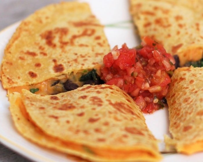 Creamy sweetpotato puree and garlicky black beans and spinach make a sweet and savory filling for gluten-free, vegetarian quesadillas. Recipe via JessicaLevinson.com #Sweetpotatoquesadillas #BlackBeanQuesadillaRecipe Sweet Potato Black Bean Quesadillas Close Up