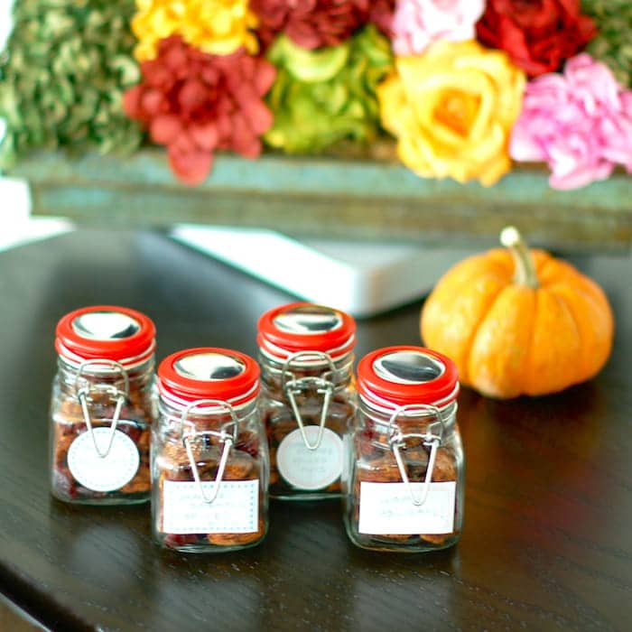 Sweet and Spicy Orange-Scented Nuts are a delicious homemade holiday gift, addition to a cocktail party spread, or anytime snack. Get the gluten-free, dairy-free, vegetarian recipe at JessicaLevinson.com | #EdibleGifts #SpicedNutsRecipe Orange-Scented Nuts in Gift Jars