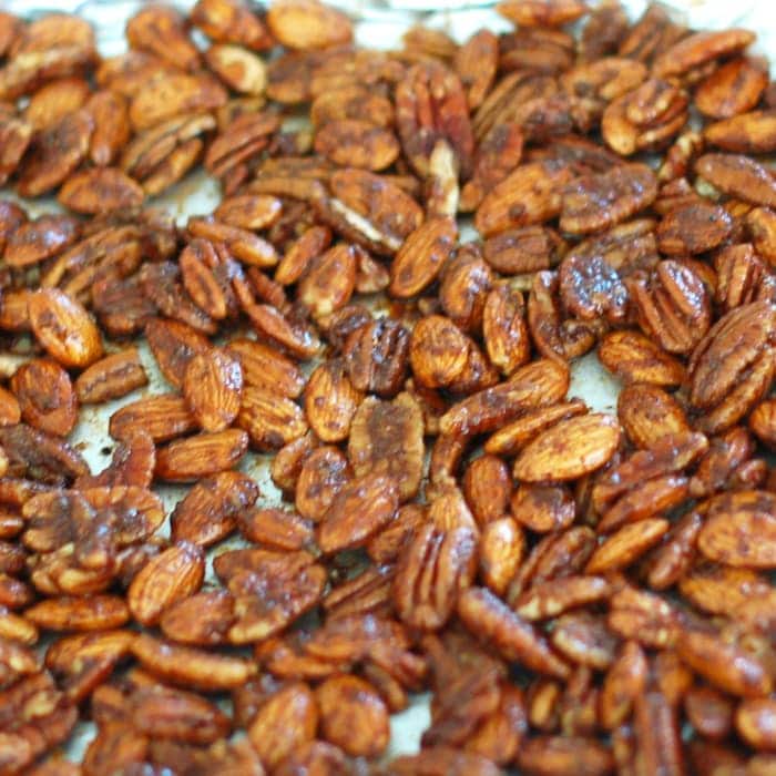 Sweet and Spicy Orange-Scented Nuts are a delicious homemade holiday gift, addition to a cocktail party spread, or anytime snack. Get the gluten-free, dairy-free, vegetarian recipe at JessicaLevinson.com | #EdibleGifts #SpicedNutsRecipe Orange-Scented Nuts on Sheet Pan