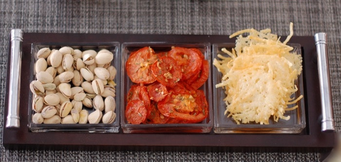 snack platter with roasted tomatoes snack platter with pistachios, roasted tomatoes, and cheese crisps