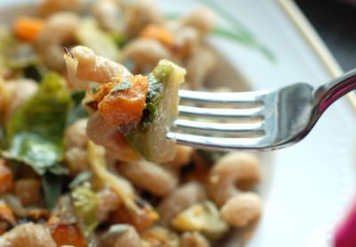 Roasted butternut squash and brussels sprouts tossed with creamy lemon-sage ricotta and a hint of maple syrup make this pasta dish nutritious and delicious, perfect for a cool fall night. Get the full recipe via JessicaLevinson.com #FallPasta #NationalPastaMonth #FallPastaRecipe Roasted Butternut Squash Pasta on Fork
