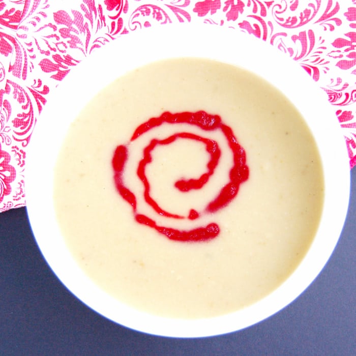 Dairy Free Parsnip Pear Soup bowl of parsnip pear soup with cranberry coulis