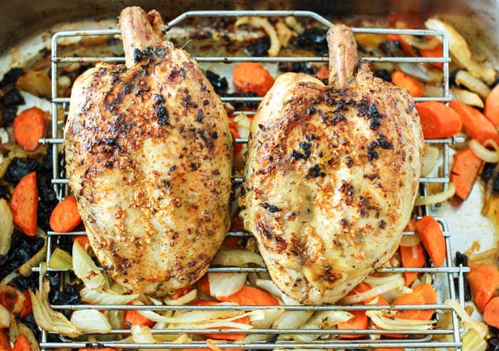 Juicy, savory, and flavorful roasted chicken with fennel, carrots, onions, and dried plums is easy enough for a weeknight meal and elegant enough for company. Also a great recipe for leftovers - if there are any! Get the gluten-free and dairy-free recipe via JessicaLevinson.com #RoastedChickenRecipe #EasyChickenRecipe Roasted Chicken with Fennel in Baking Pan