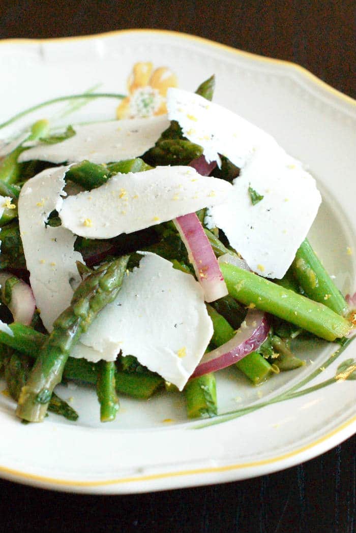 Earthy asparagus is tossed with crisp red onions, refreshing mint, zesty lemon, and salty ricotta salata cheese in this Asparagus Mint Salad that will get you in the spirit of spring and wake up your taste buds. Get the vegetarian and gluten-free recipe at JessicaLevinson.com #SpringRecipes #AsparagusSalad #SpringSalads Asparagus Mint Salad on Plate
