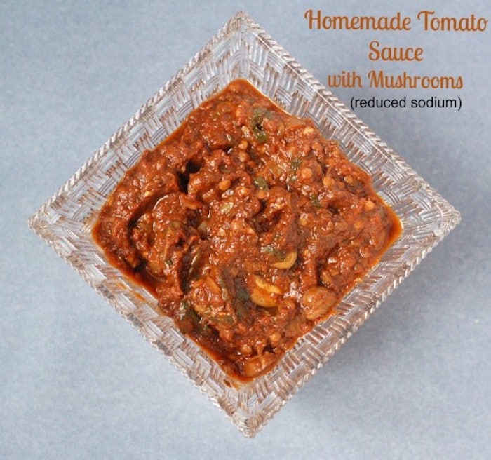 Mushrooms, balsamic vinegar, and tomato paste join together to add a rich, deep umami flavor to this homemade tomato sauce that's lower in sodium than most store-bought varieties. Get the vegan recipe via JessicaLevinson.com #VeganTomatoSauceRecipe #HomemadeTomatoSauceRecipe Easy Homemade Tomato Sauce Recipe with Text