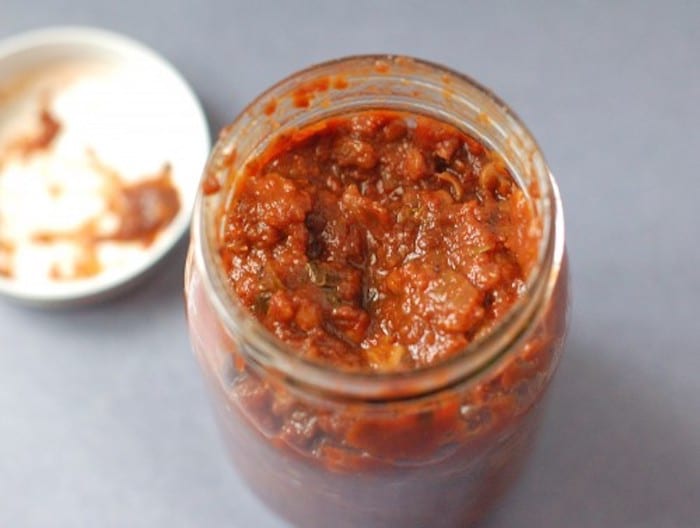 Mushrooms, balsamic vinegar, and tomato paste join together to add a rich, deep umami flavor to this homemade tomato sauce that's lower in sodium than most store-bought varieties. Get the vegan recipe via JessicaLevinson.com #VeganTomatoSauceRecipe #HomemadeTomatoSauceRecipe Easy Homemade Tomato Sauce in Glass Jar