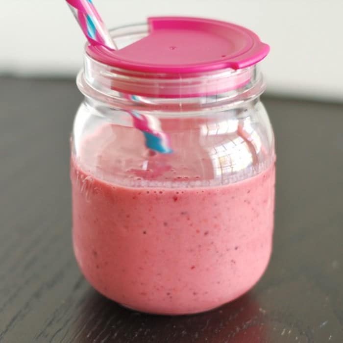 AD | This creamy mixed berry yogurt smoothie is fiber-rich and an excellent source of vitamin C, potassium, and calcium. Get the gluten-free and vegetarian recipe via JessicaLevinson.com #BerrySmoothieRecipe #HealthySmoothieRecipe Mixed Berry Yogurt Smoothie in Glass with Straw
