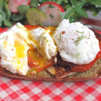 Smoky halloumi, fragrant roasted tomatoes, creamy avocado, and poached eggs top whole grain sourdough bread in this Mediterranean style egg and cheese sandwich. Get the recipe @ JessicaLevinson.com | #eggs #eggandcheese #meditteraneandiet #breakfast #brunch #breakfastfordinner #vegetarian