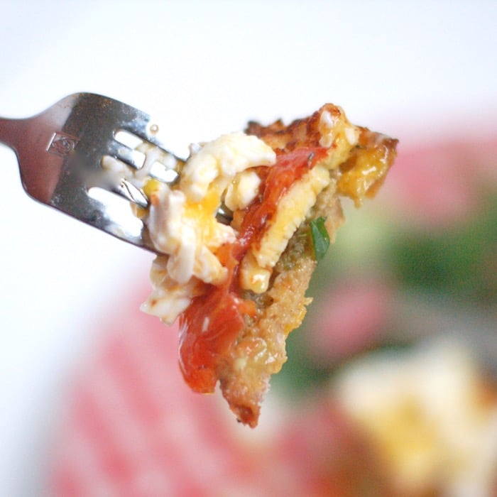 Smoky halloumi, fragrant roasted tomatoes, creamy avocado, and poached eggs top whole grain sourdough bread in this Mediterranean style egg and cheese sandwich. Get the recipe @ JessicaLevinson.com | #eggs #eggandcheese #meditteraneandiet #breakfast #brunch #breakfastfordinner #vegetarian Perfect bite of mediterranean style egg and cheese