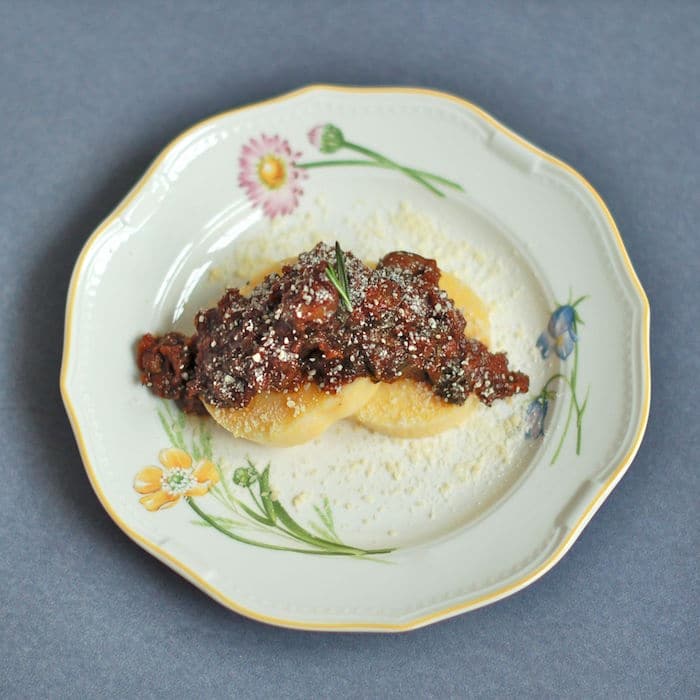 Umami-rich, vegetarian lentil bolognese served over polenta cakes or your favorite pasta is a filling and flavorful dinner. Recipe via JessicaLevinson.com | #Lentils #vegetarianrecipe Umami-rich, vegetarian lentil bolognese served over polenta cakes or your favorite pasta is a filling and flavorful dinner meal.