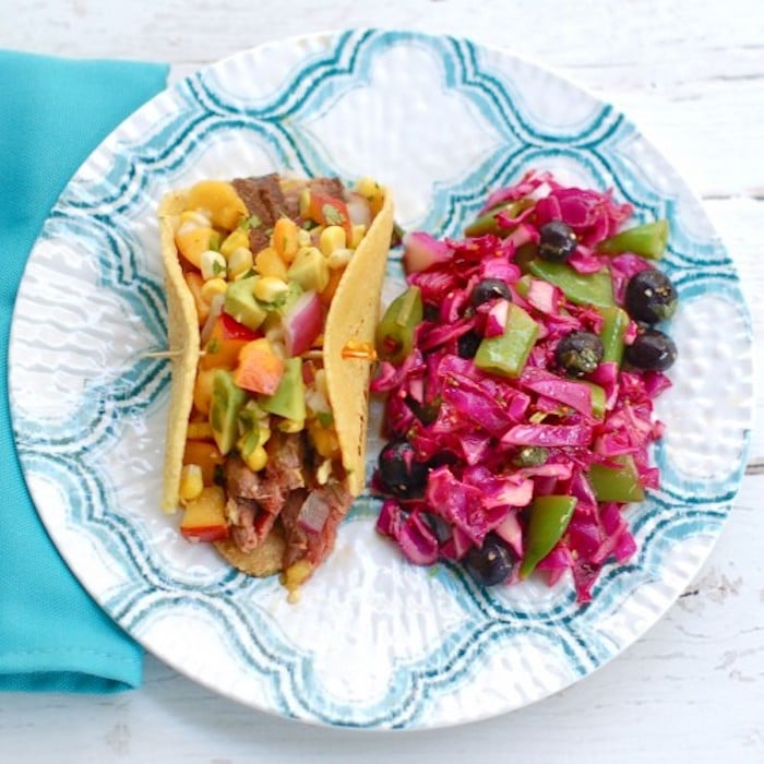 Enjoy the nutrition and health benefits of lean beef with this juicy soy-marinated flank steak taco topped with a colorful and nutritious nectarine corn salsa brimming with the flavors of summer @jlevinsonRD #sponsored #summertacos #steaktacosrecipe Soy-Marinated Steak Tacos with Red Cabbage Slaw