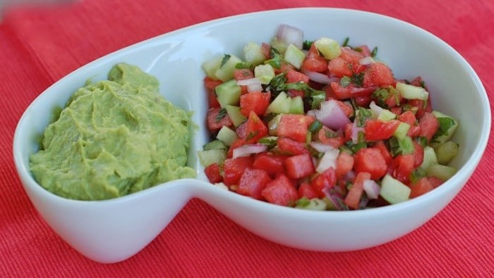 Flavorful and refreshing watermelon salsa is a fun summer twist on a classic. Serve with chips, over fish or beef tacos, on top of salads, or with grilled chicken. Get the gluten-free and vegan recipe at JessicaLevinson.com #WatermelonSalsaRecipe #SummerSalsa #SummerRecipes Watermelon Salsa in Dish with Guacamole