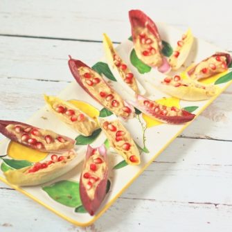 Wow your guests with zesty, creamy lemon hummus endive boats topped with sweet and juicy pomegranate seeds. A pretty, flavorful, nutritious and delicious appetizer perfect for a crowd. 