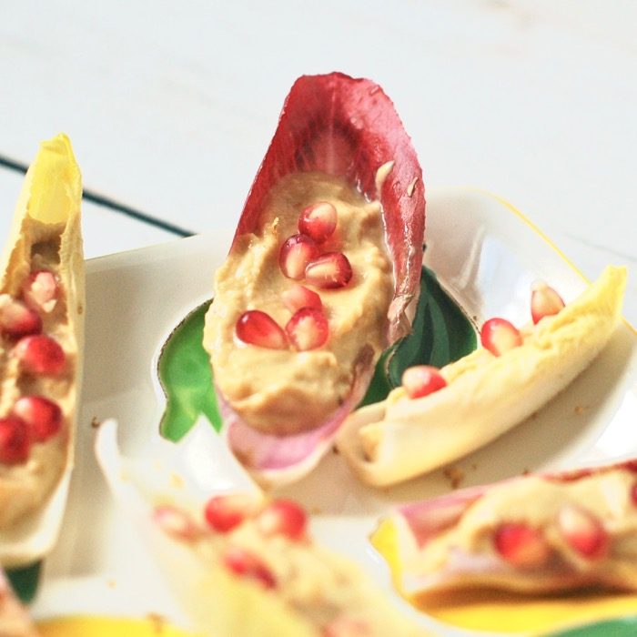 Wow your guests with zesty, creamy lemon hummus endive boats topped with sweet and juicy pomegranate seeds. A pretty, flavorful, nutritious and delicious appetizer perfect for a crowd. quick and easy appetizer for a crowd. lemon hummus endive boats