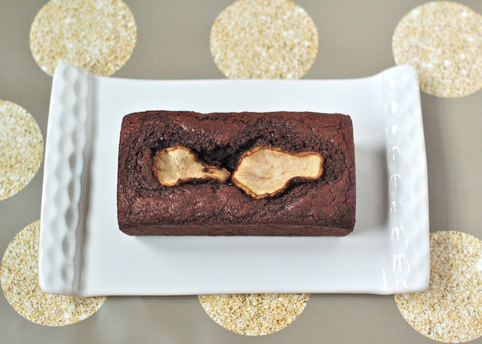 Rich chocolate pear bread is easy to make, moist, and delicious. Plus it’s a good source of fiber and calcium. Vegetarian and nut-free. Chocolate pear bread on platter