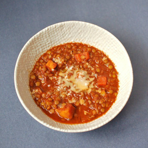 Warm up with a bowl of hearty lentil chili that's packed with vegetables and brimming with flavor and nutrition. Enjoy topped with shredded cheese or mashed avocado. Get the vegan and gluten-free recipe via JessicaLevinson.com #VeganChili #VegetarianChiliRecipe Overhead Hearty Vegetable Lentil Chili