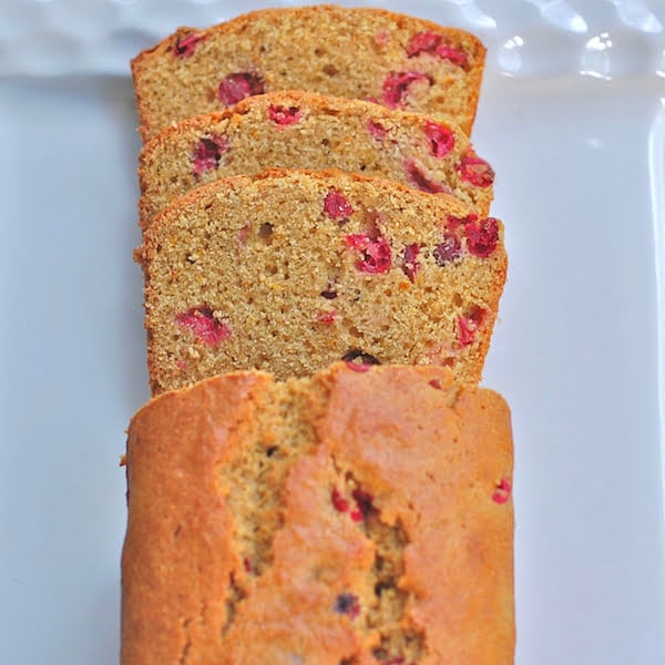 Cranberry Orange Bread | This whole-grain Cranberry Orange Bread will keep you healthy all winter long thanks to antioxidant-rich cranberries and vitamin C-rich oranges. Get this dairy-free and nut-free recipe @jlevinsonrd | #QuickBreadRecipe | #FallBaking | #QuickBreads Cranberry Orange Bread Sliced