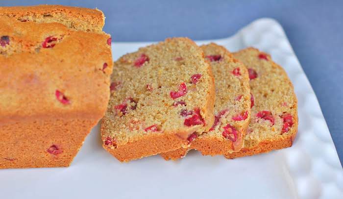 Cranberry Orange Bread | This whole-grain Cranberry Orange Bread will keep you healthy all winter long thanks to antioxidant-rich cranberries and vitamin C-rich oranges. Get this dairy-free and nut-free recipe @jlevinsonrd | #QuickBreadRecipe | #FallBaking | #QuickBreads Sliced Cranberry Orange Bread