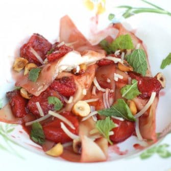 lemon ricotta filled ravioli with roasted strawberries and hazelnuts