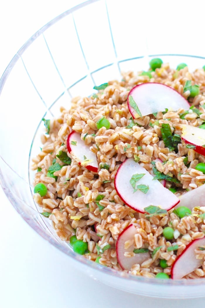 pea and radish farro salad in serving bowl spring farro salad in cut glass serving bowl