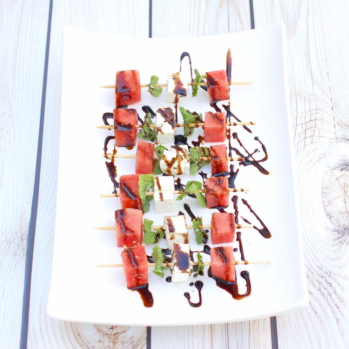 watermelon, feta, and mint skewers are a delicious finger food for a summer party watermelon feta mint skewers on serving platter