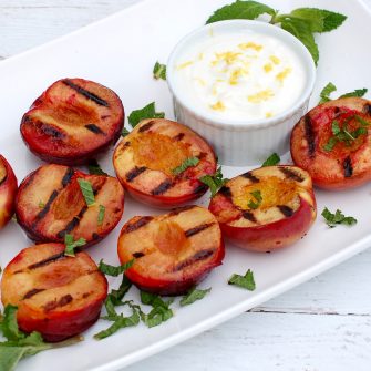 Grilled Stone Fruit with Yogurt Sauce is a naturally delicious, low-calorie, vegetarian and gluten-free end to your summer BBQ. Get the recipe @jlevinsonrd.