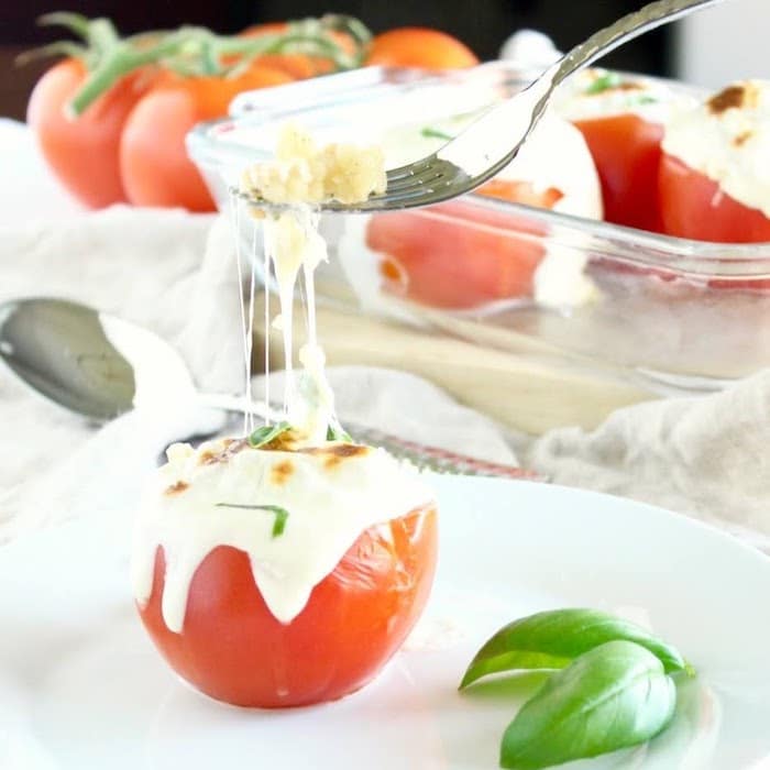 Learn about the varieties, health benefits, & culinary uses of fresh summer tomatoes. Then enjoy delicious & healthy Caprese Couscous Stuffed Tomatoes! Get the quick and easy, vegetarian recipe @jlevinsonrd #capresetomatoes #vegetarianstuffedtomatoes Caprese Couscous Stuffed Tomatoes Fork of Stringy Cheese