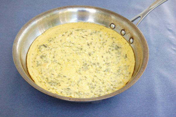 Farinata with Tomato, Mozzarella, & Pesto Drizzle | A chickpea flour crust is topped with tomatoes, mozzarella, and basil pesto in this easy, gluten-free, vegetarian twist on traditional Italian farinata | Get the recipe via JessicaLevinson.com #farinatarecipe #ChickpeaFlour #ItalianRecipes Crust of Farinata with Tomato Mozzarella and Pesto