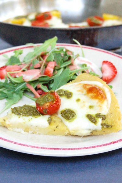Farinata with Tomato, Mozzarella, & Pesto Drizzle | A chickpea flour crust is topped with tomatoes, mozzarella, and basil pesto in this easy, gluten-free, vegetarian twist on traditional Italian farinata | Get the recipe via JessicaLevinson.com #farinatarecipe #ChickpeaFlour #ItalianRecipes Farinata with Tomato Mozzarella and Pesto on Plate
