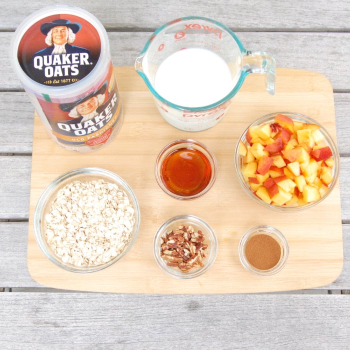 Ingredients to make peaches and cream overnight oats: peaches, oats, pecans, maple syrup, kefir, and cinnamon peaches and cream overnight oats ingredients