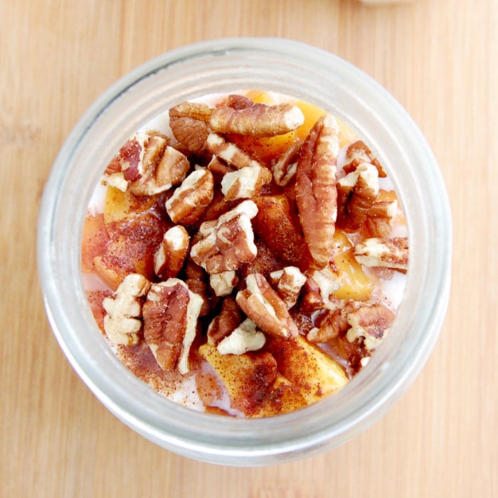 maple roasted peaches and pecans top this make-ahead breakfast of peaches and cream overnight oats peaches and cream overnight oats overhead shot