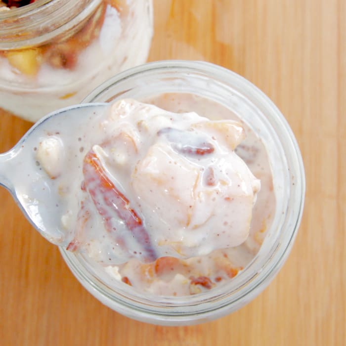each delicious bite of peaches and cream overnight oats has creamy kefir, sweet, juicy peaches, and crunchy pecans. spoonful of Peaches and Cream overnight oats
