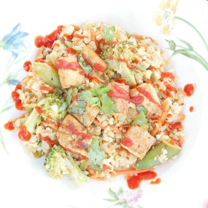 This cauliflower fried rice is packed with vegetables and protein, and is much healthier than the classic Chinese take-out version. Get the Vegetarian, Vegan-friendly & Gluten-free recipe via JessicaLevinson.com #CauliflowerFriedRiceRecipe #CauliflowerRice Cauliflower Fried Rice Overhead