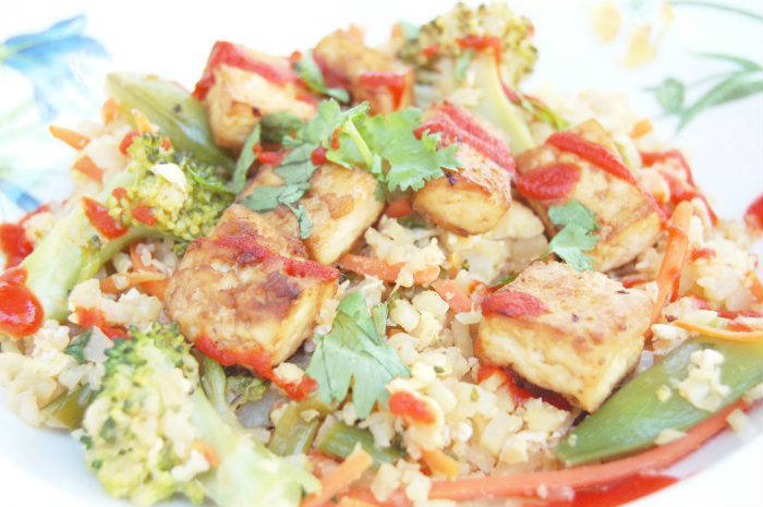 This cauliflower fried rice is packed with vegetables and protein, and is much healthier than the classic Chinese take-out version. Get the Vegetarian, Vegan-friendly & Gluten-free recipe via JessicaLevinson.com #CauliflowerFriedRiceRecipe #CauliflowerRice Cauliflower Fried Rice Close-Up