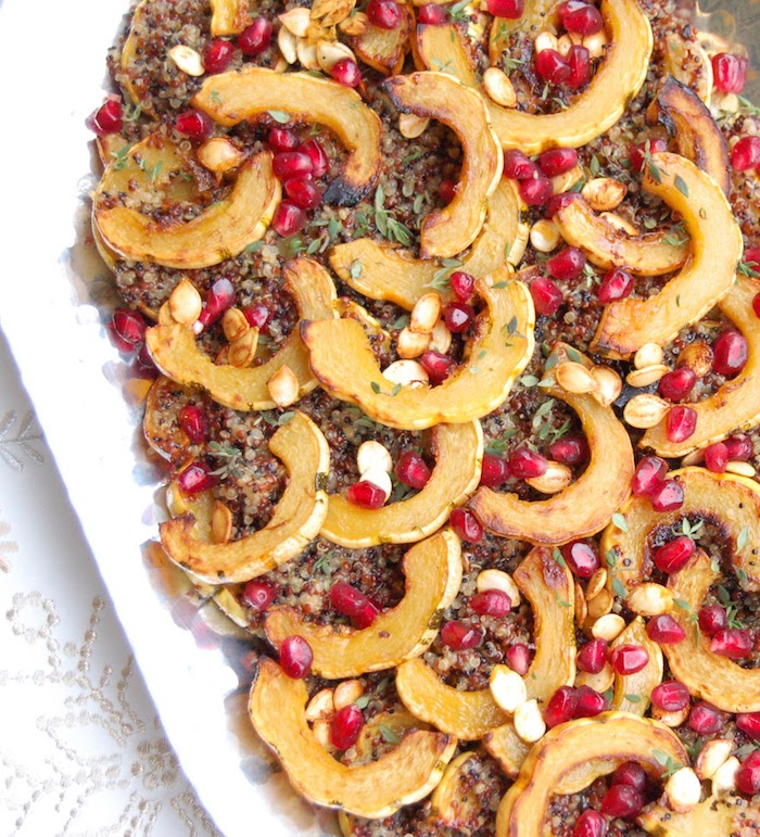 Maple-roasted delicata squash tops cider-infused quinoa and is garnished with thyme and pomegranate seeds in this easy, yet elegant side dish that's perfect for the holidays or any day of the week. Recipe via JessicaLevinson.com #VeganRecipe #QuinoaSaladRecipe #FallSideDish Maple-Roasted Delicata Squash Quinoa Salad Closeup