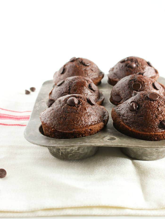 Delicious whole grain double chocolate muffins taste sinful but aren’t! A great make-ahead breakfast treat or healthier dessert. Get this vegetarian and nut-free recipe at JessicaLevinson.com | #WholeGrainMuffins #ChocolateMuffins #BreakfastMuffins Double Chocolate Muffins in Muffin Pan