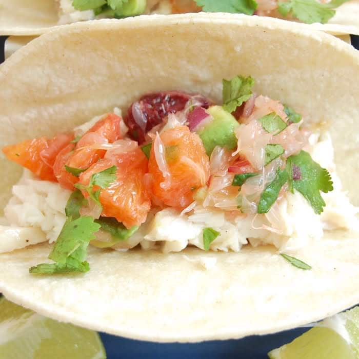Fish Tacos with Citrus Salsa are a quick and easy, flavor-packed dinner the whole family will enjoy. Get the gluten-free, dairy-free recipe via JessicaLevinson.com #fishtacos #citrusrecipe #healthytacos Overhead Close Up Fish Tacos with Citrus Salsa