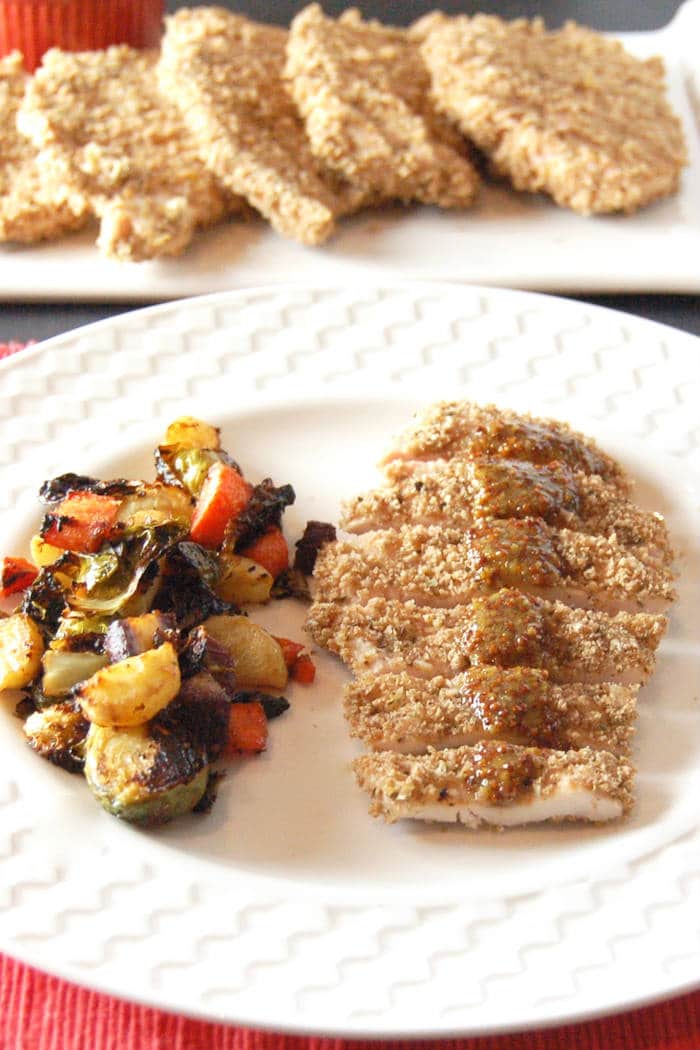 Satisfy your kids' cravings for chicken fingers in a healthier way with this crispy whole grain baked panko crusted chicken. Serve with a simple honey mustard sauce for a dinner the whole family will love. via JessicaLevinson.com | #dairyfreechicken #nutfreebakedchicken #healthierbakedchicken Panko Crusted Chicken on Plate
