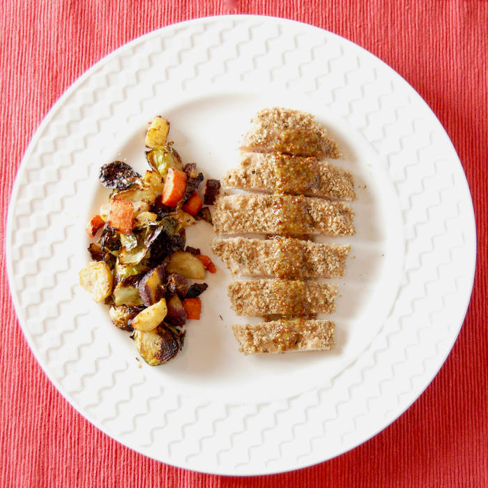 Satisfy your kids' cravings for chicken fingers in a healthier way with this crispy whole grain baked panko crusted chicken. Serve with a simple honey mustard sauce for a dinner the whole family will love. via JessicaLevinson.com | #dairyfreechicken #nutfreebakedchicken #healthierbakedchicken Overhead Panko Crusted Chicken