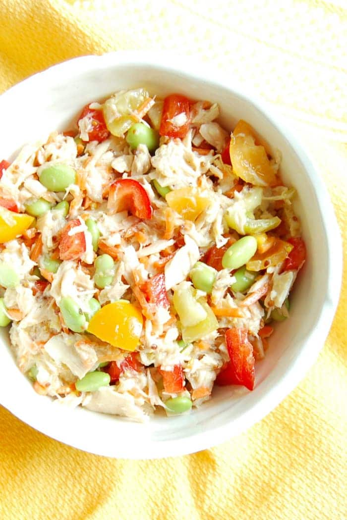 Quick and Easy Tuna Edamame Salad is a healthy, delicious, and balanced lunch the whole family can enjoy. Ready in less than ten minutes, it's perfect for the kids' lunchboxes or over a bed of greens for adults. Recipe via JessicaLevinson.com | #glutenfree #dairyfree #nutfree #eggfree #healthyrecipes #seafood2xWk #tunafish #lunchrecipes #lunchbox Easy Tuna Edamame Salad Recipe in White Bowl Overhead