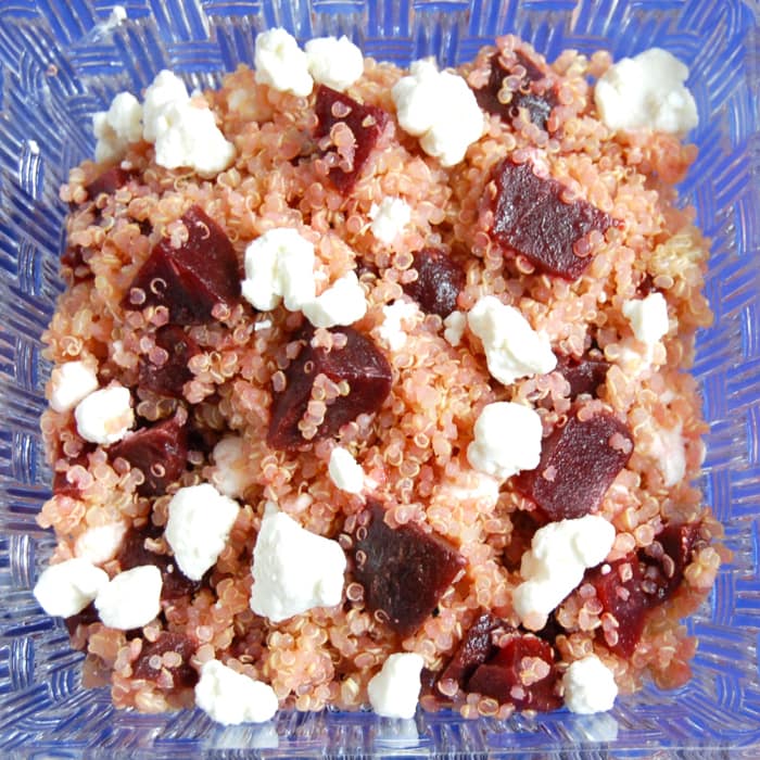 Beet and Goat Cheese Quinoa Salad is a simple pairing for a quick and easy lunch. Delicious on its own, over a bed of greens, or as a side dish next to your main course. Get the vegetarian, gluten-free, and nut-free recipe via JessicaLevinson.com #QuinoaSaladRecipe #BeetandGoatCheeseSalad Close up of Beet and Goat Cheese Quinoa Salad