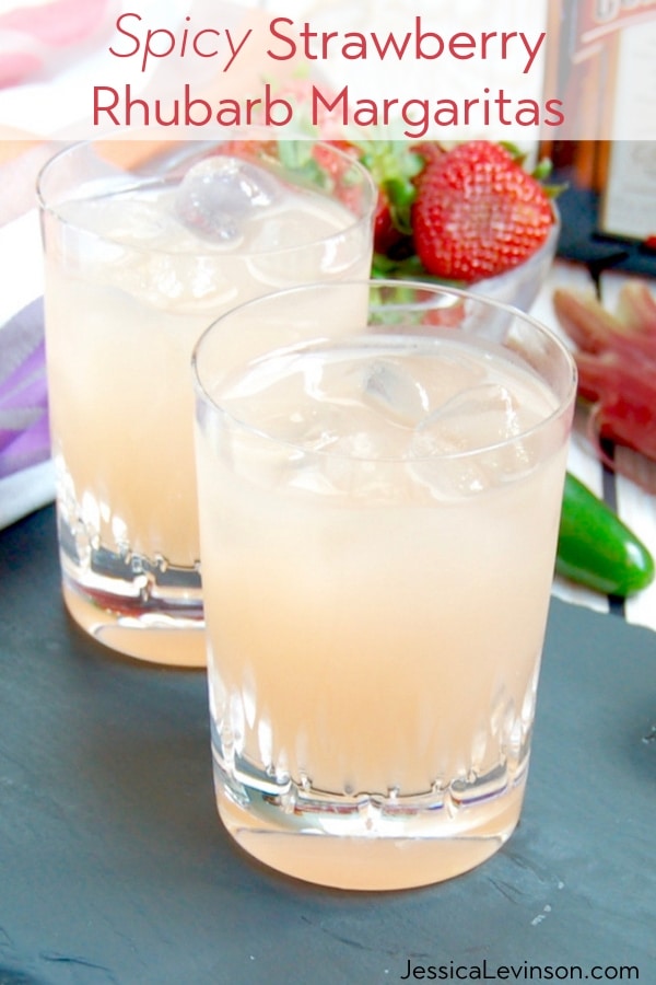 Spicy Strawberry Rhubarb Margaritas are the perfect complement for Taco Tuesdays or any Mexican-themed party during the spring and summer. Get the cocktail recipe at JessicaLevinson.com | #cincodemayo #margaritas #cocktails #mocktails two glasses of spicy strawberry rhubarb margaritas