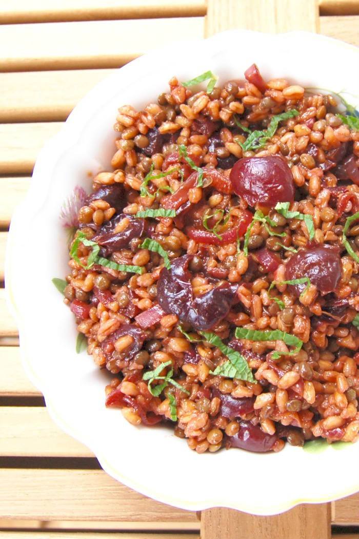 Roasted Cherry Farro Salad is a sweet and savory dish hearty enough for a light lunch and perfect as a side dish next to your favorite entrée. Get the vegan and nut-free recipe via JessicaLevinson.com #FarroSaladRecipe #CherryRecipe #HealthySaladRecipe Roasted Cherry Farro Salad Closeup