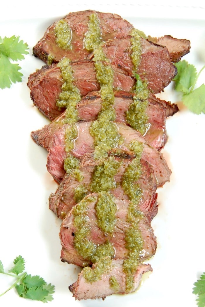 Perfectly grilled Cilantro Lime Steak is easy to make and a delicious entrée to serve guests at your summer barbecue. Recipe via JessicaLevinson.com | #GrilledSteakRecipe #SteakMarinadeRecipe Grilled Cilantro Lime Steak Sliced Close Up