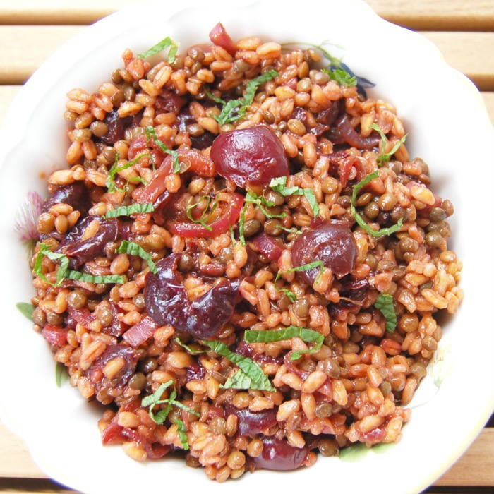 Roasted Cherry Farro Salad is a sweet and savory dish hearty enough for a light lunch and perfect as a side dish next to your favorite entrée. Get the vegan and nut-free recipe via JessicaLevinson.com #FarroSaladRecipe #CherryRecipe #HealthySaladRecipe Roasted Cherry Farro Salad Overhead