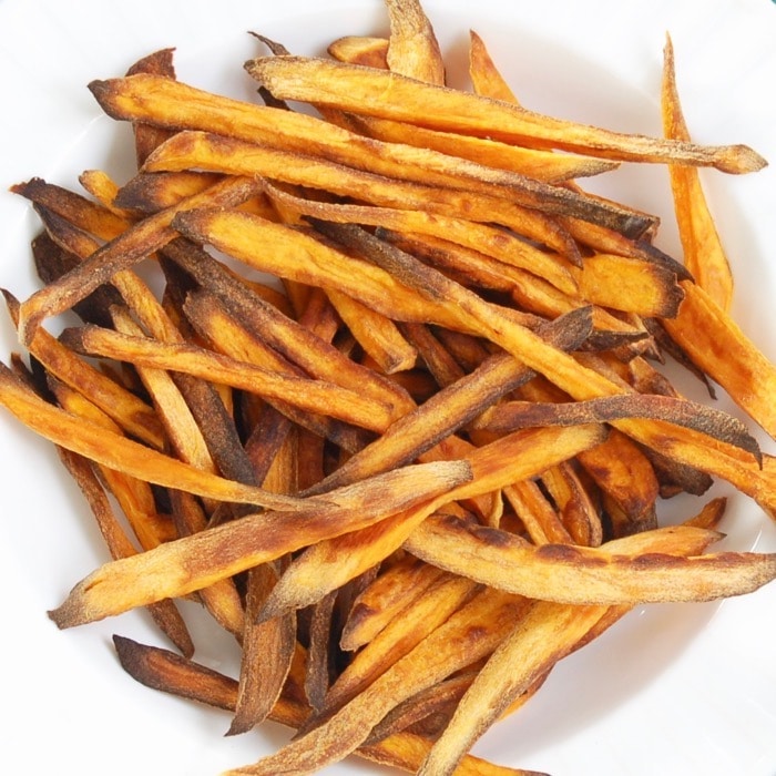 Crispy baked sweet potato fries are easy to make, kid-friendly, and delicious. The perfect side dish for any weeknight family dinner! Get the recipe at JessicaLevinson.com #HealthySweetPotatoFries #BakedSweetPotatoFriesRecipe Crispy Baked Sweet Potato Fries Close Up