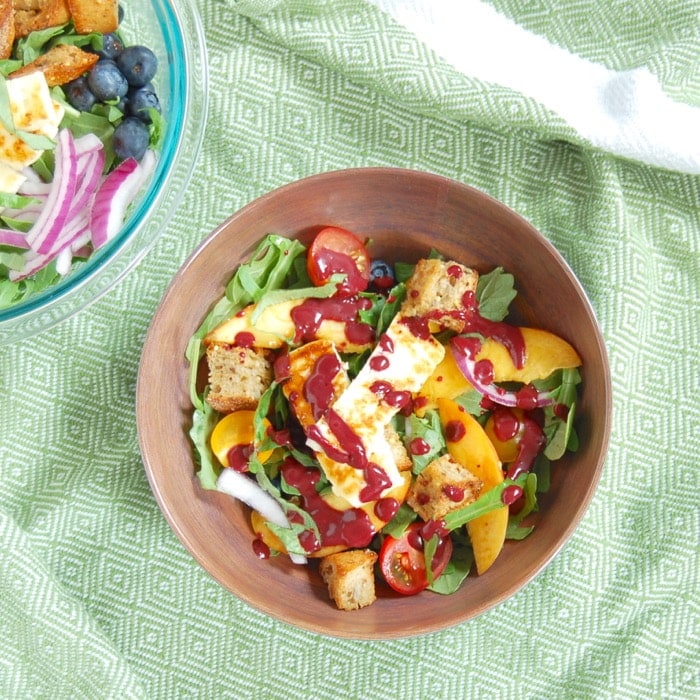 bowl of peach panzanella salad tossed with blueberry balsamic salad dressing bowl of peach panzanella salad tossed with blueberry balsamic salad dressing