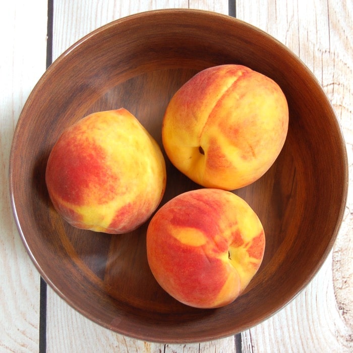 Ripe summer peaches used in peach panzanella salad bowl of summer peaches