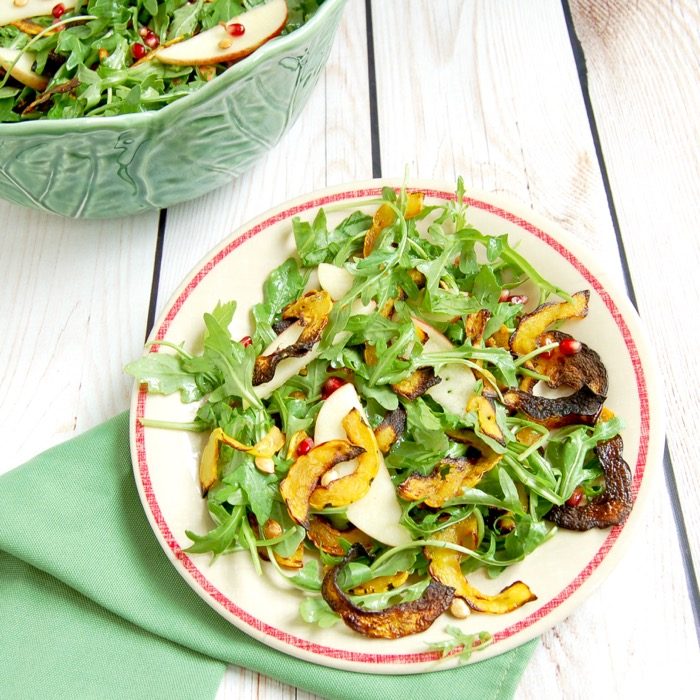 Enjoy the flavors of fall with this pretty and delicious Roasted Delicata Squash Apple Salad. A perfect side dish or starter salad, especially for the holidays. via JessicaLevinson.com | #pomegranates #delicatasquash #fallrecipes #salad #vegan #dairyfree #glutenfree #nutfree #apples delicata squash recipes